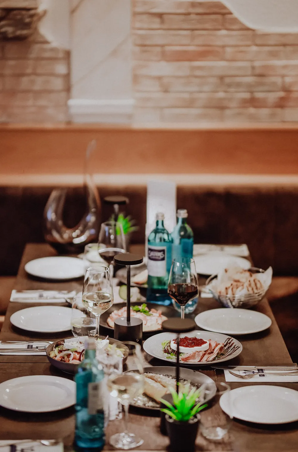 A shared table with Greek starters and wine