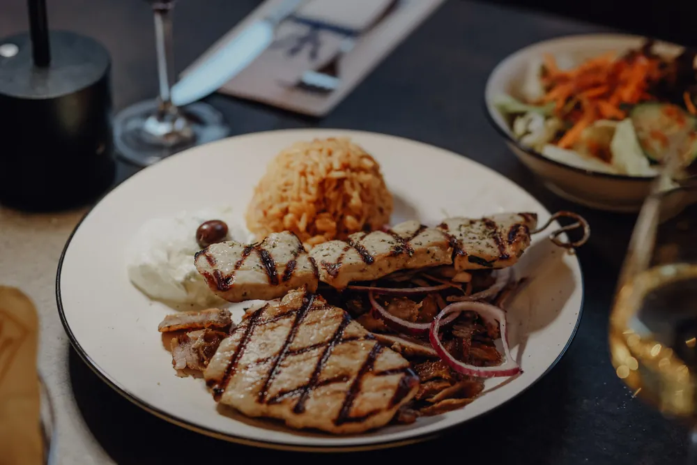 Grill platter with a meat skewer, gyros and rice