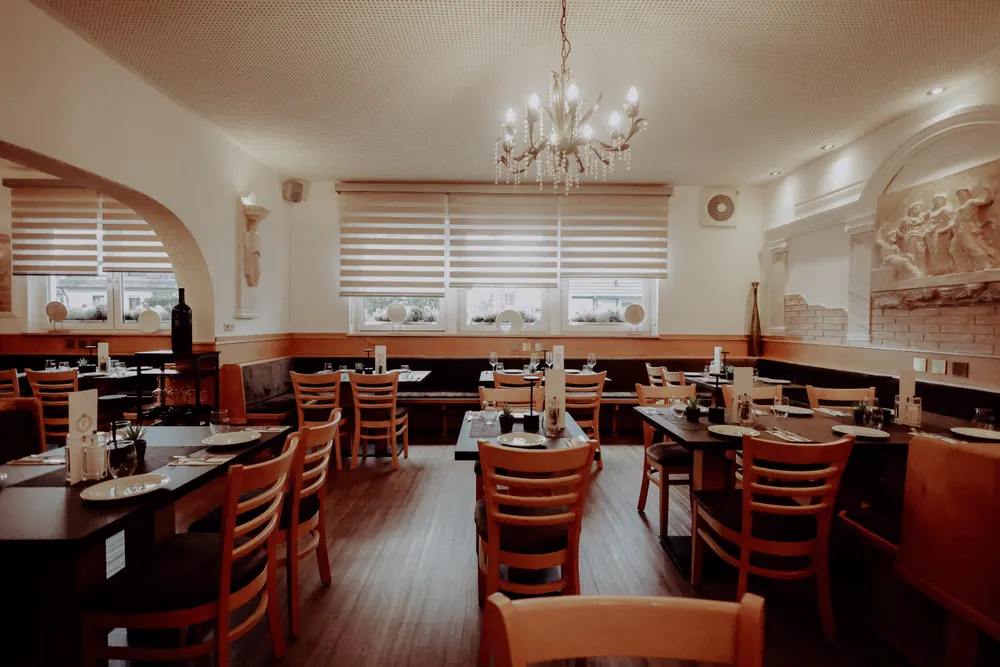 Dining room with set tables and a chandelier